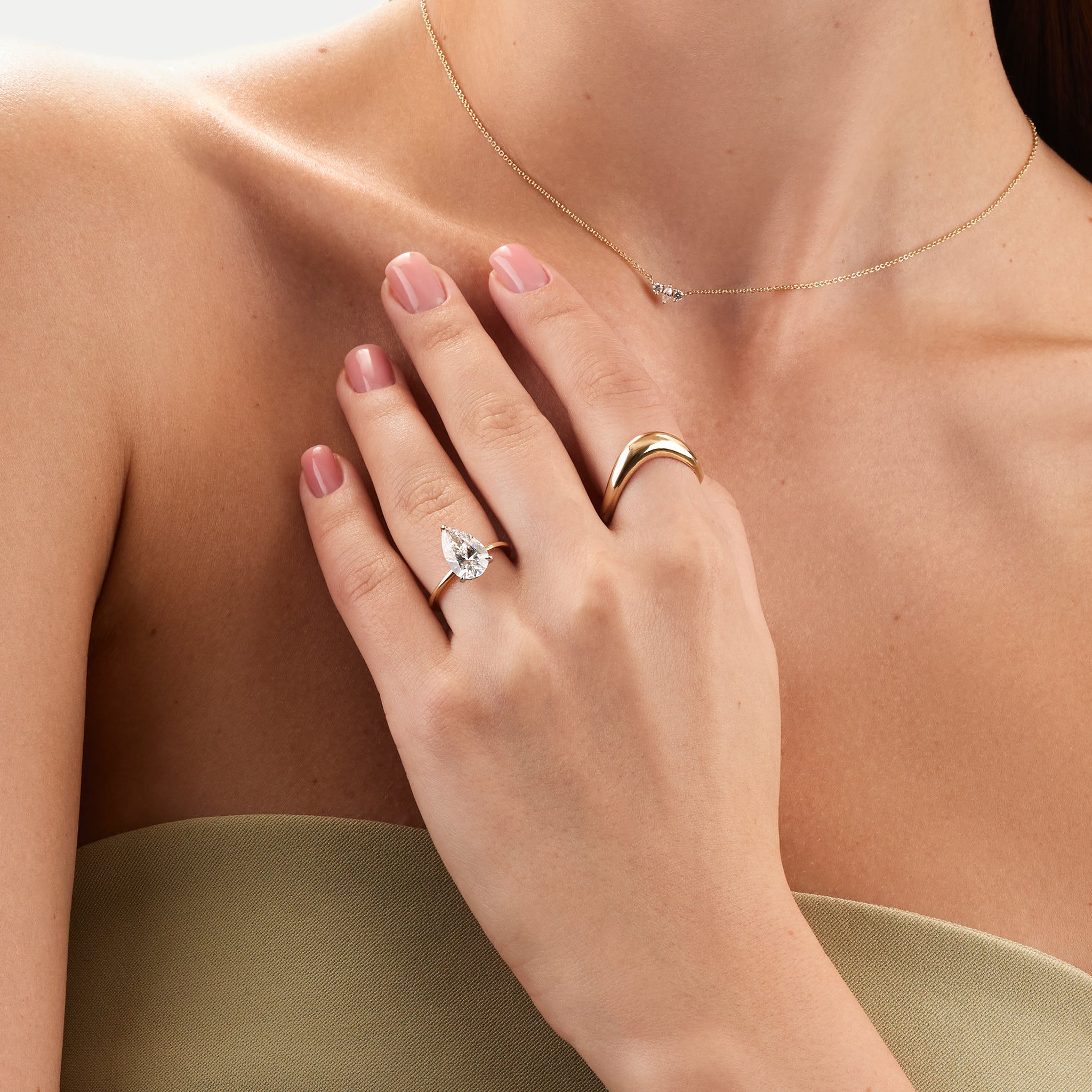 lab diamond pear engagement ring  on model.