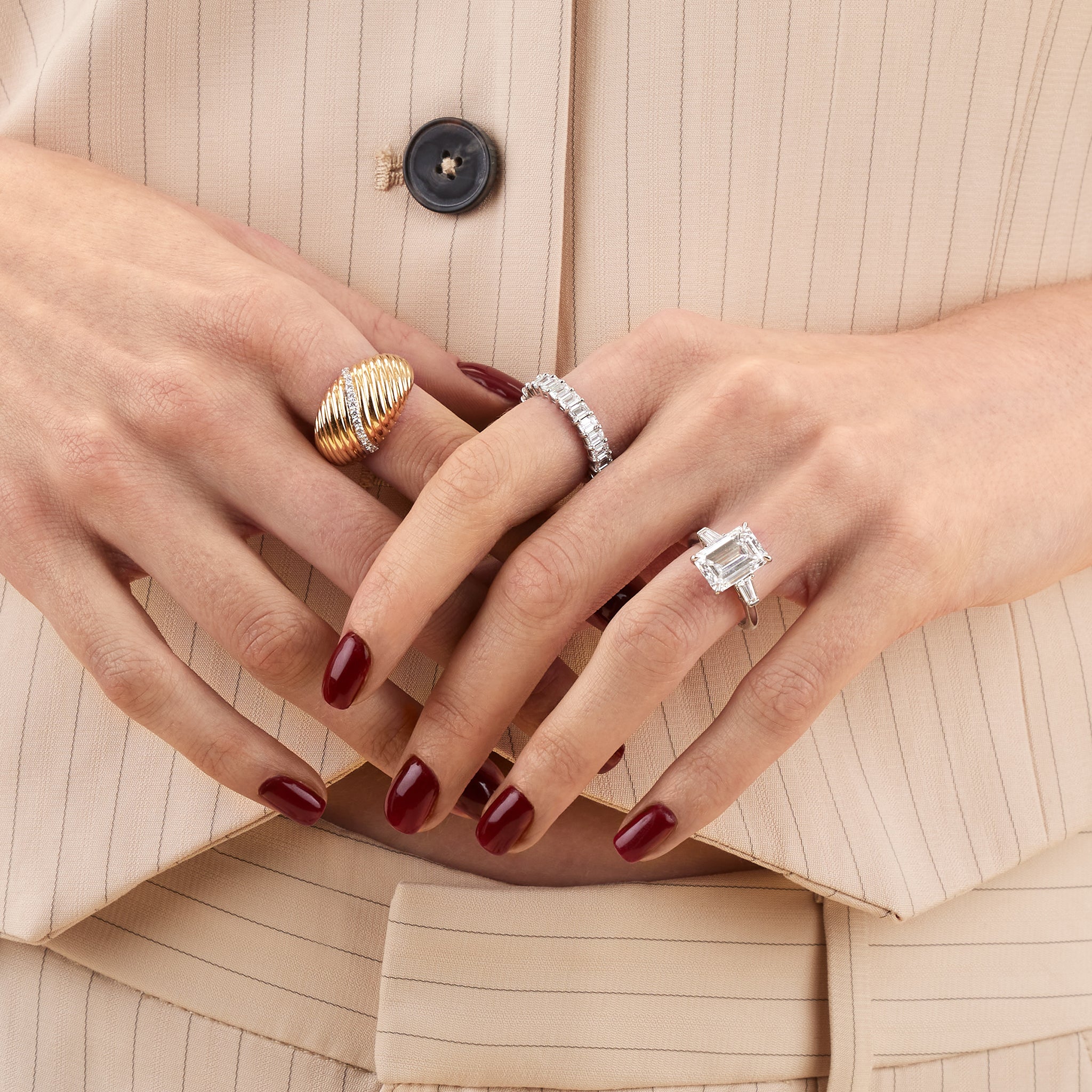 Three stone emerald lab diamond engagement ring on model