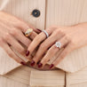 Three stone emerald lab diamond engagement ring on model