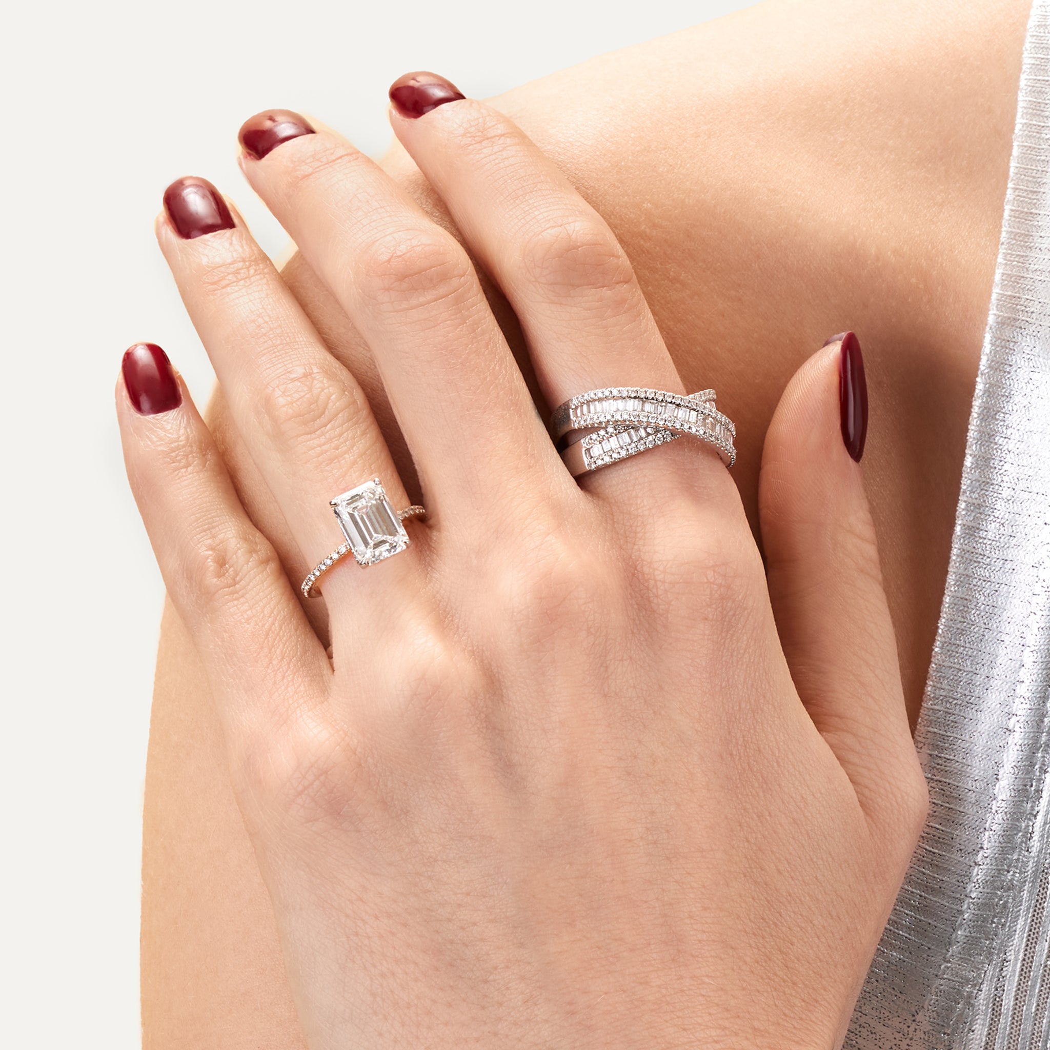 Emerald lab diamond engagement ring on model.