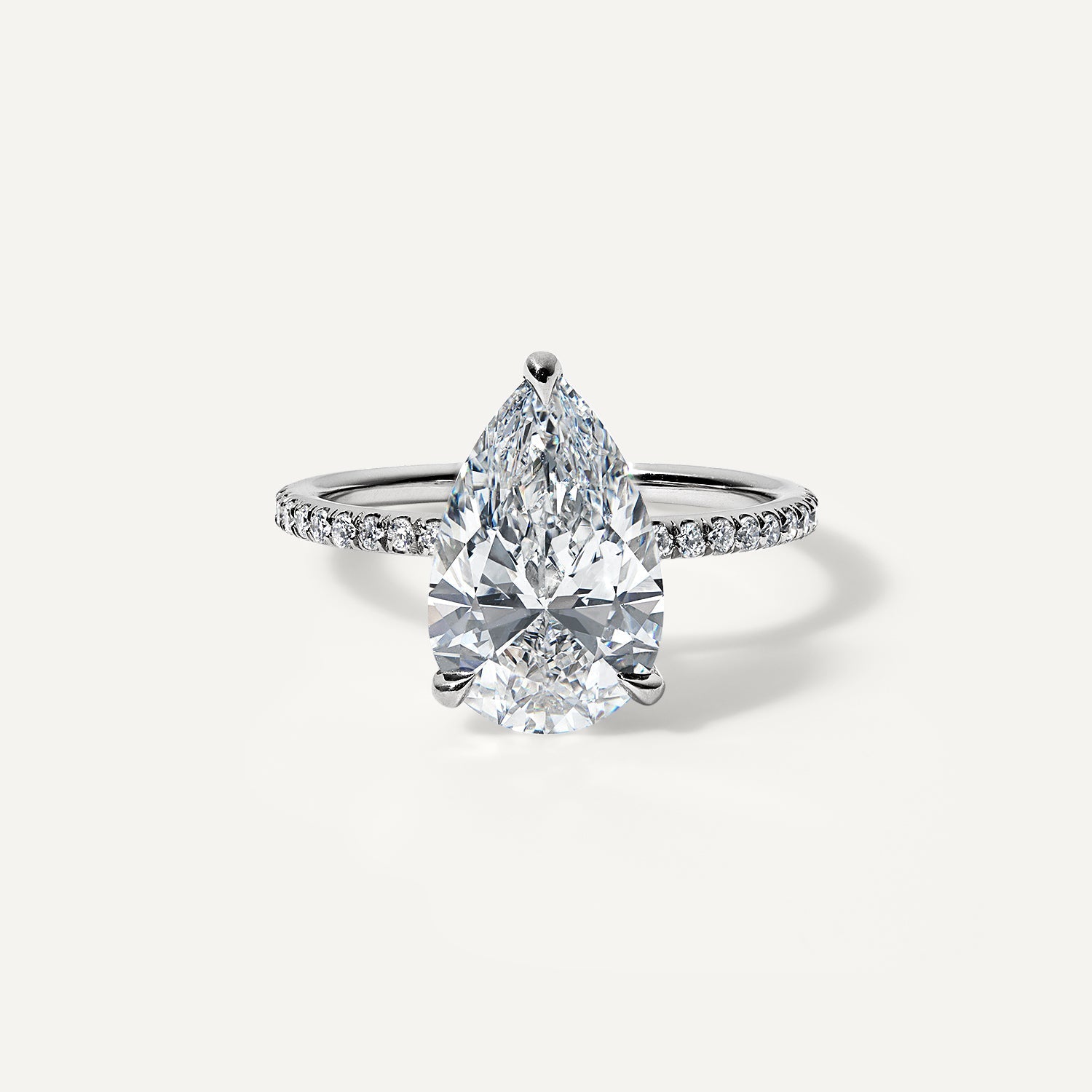 Pear lab diamond engagement ring with pave band.