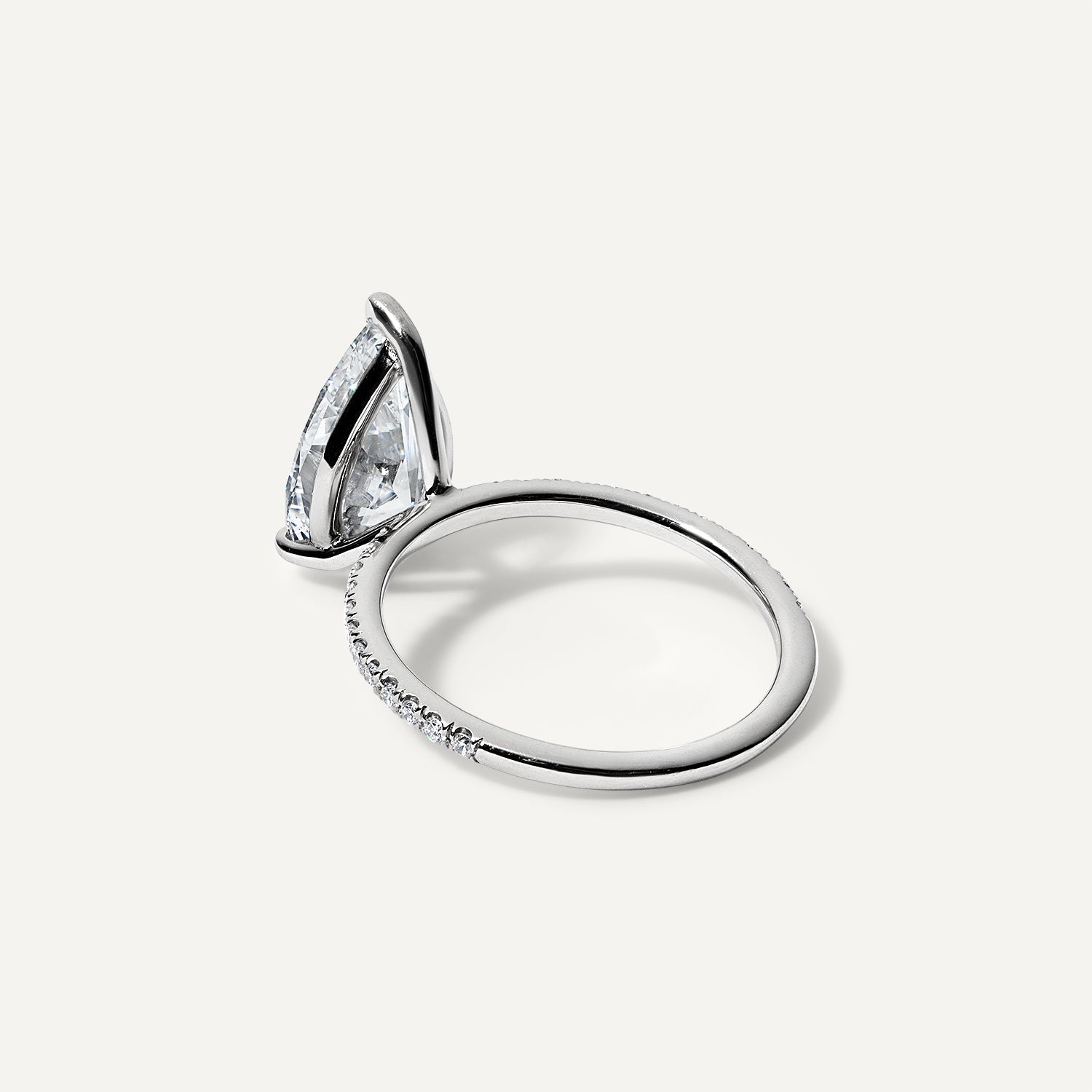Pear lab diamond engagement ring with pave band side view