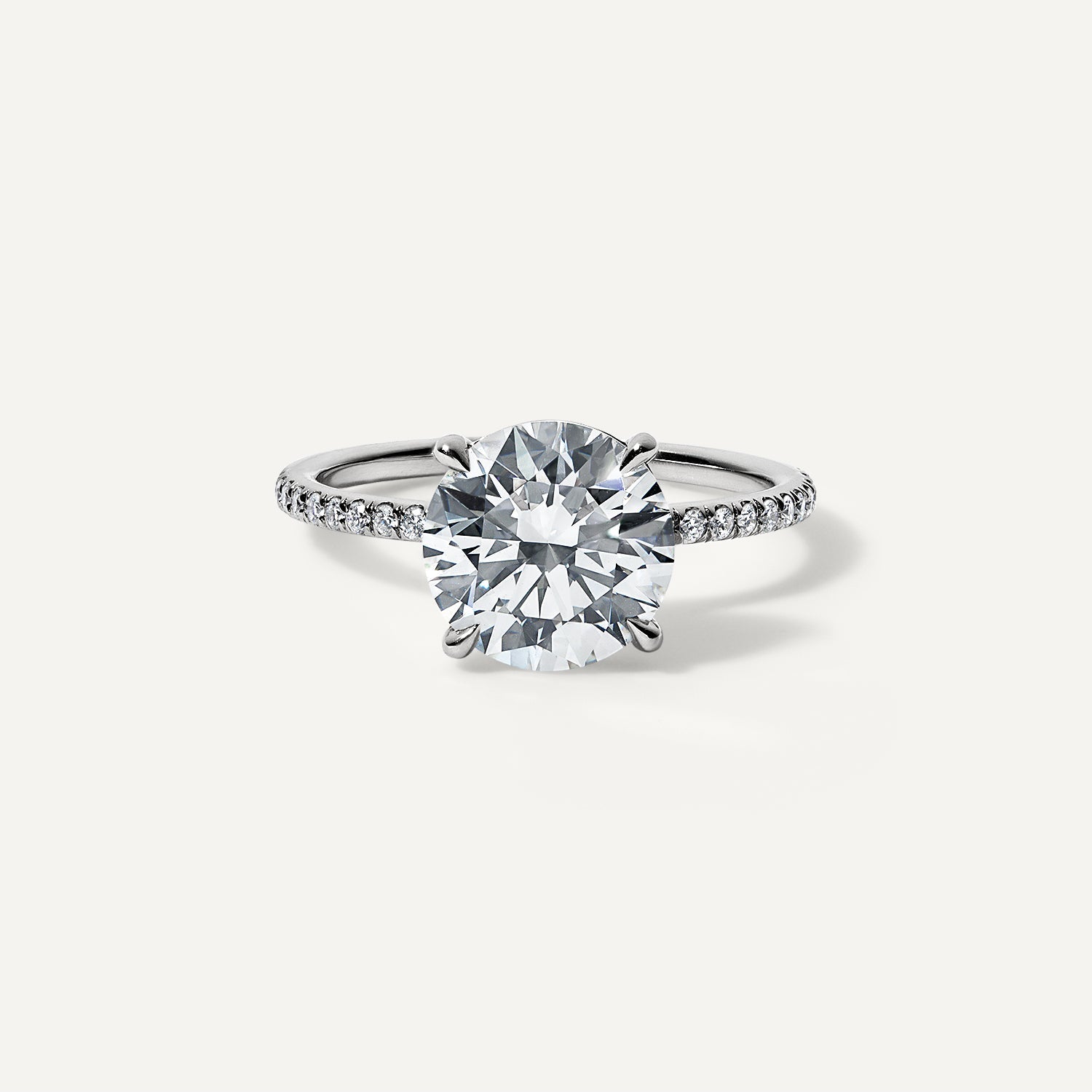 Round lab diamond engagement ring with pave band.