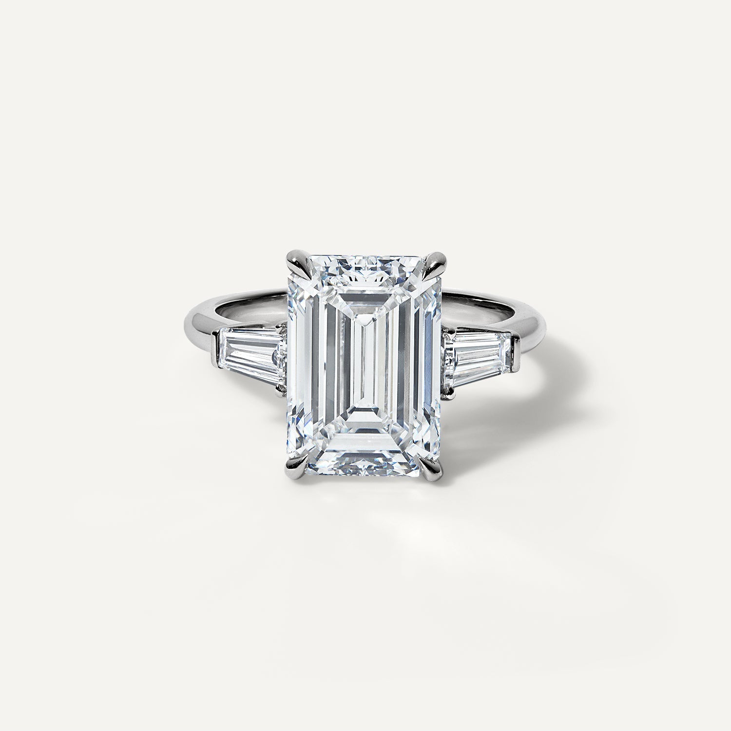 Three stone emerald lab diamond engagement ring.