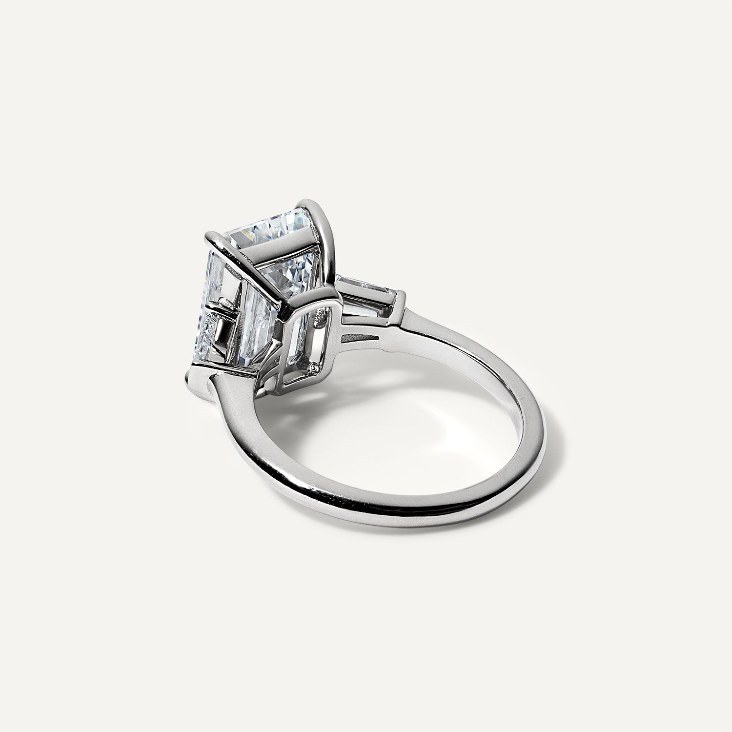 Three stone emerald lab diamond engagement ring.