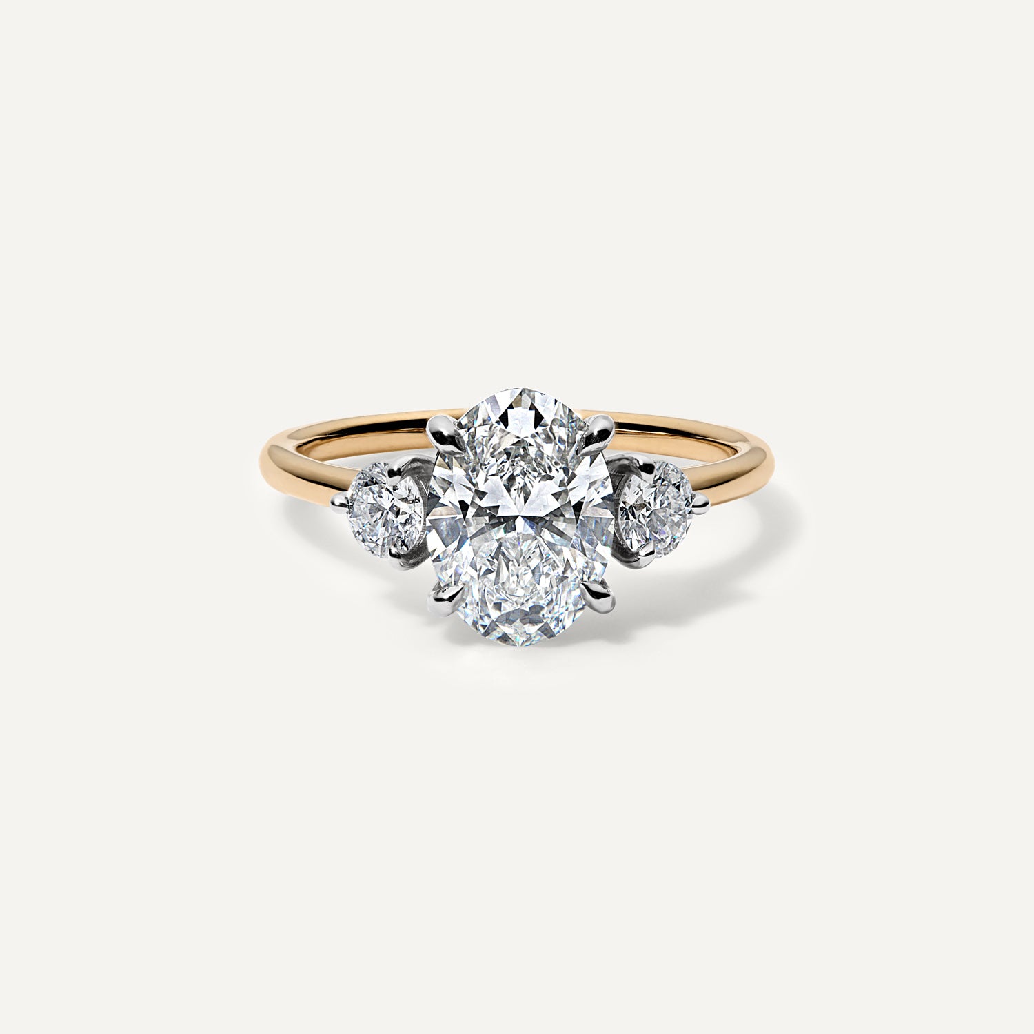 Three stone oval lab diamond engagement ring.